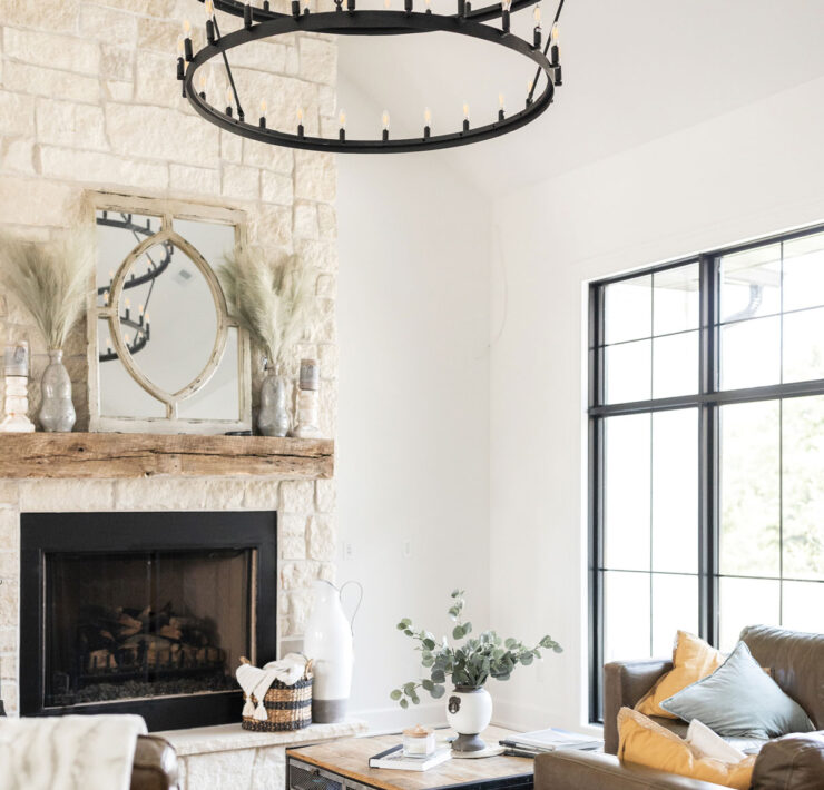 Living Room Chandelier And Floor To Ceiling Stone Fireplace