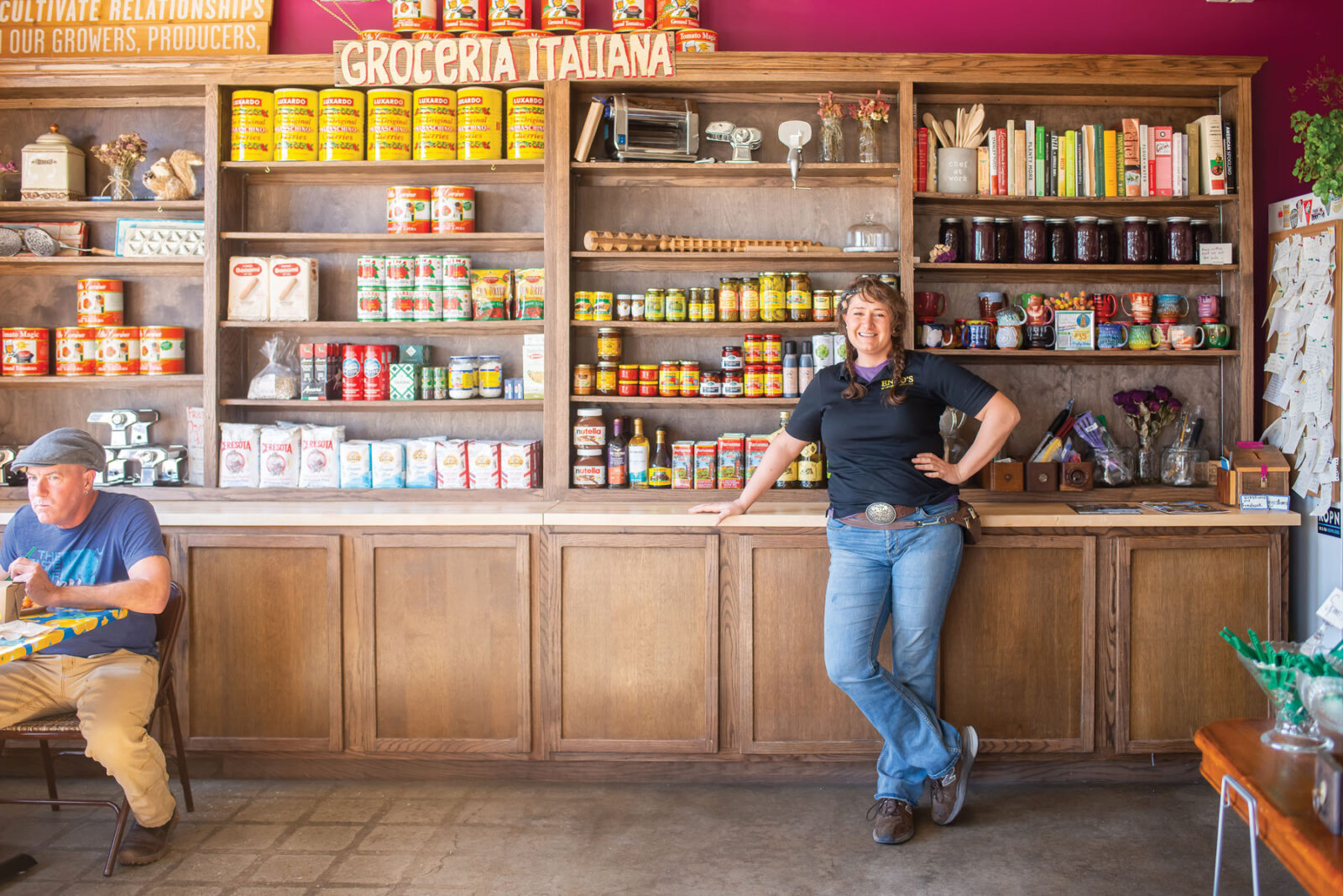 Shelly La Fata Standing Against Shelves