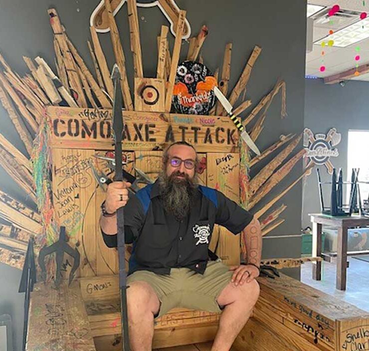 The owner of Witches And Wizards Arcade sits on the venue's throne