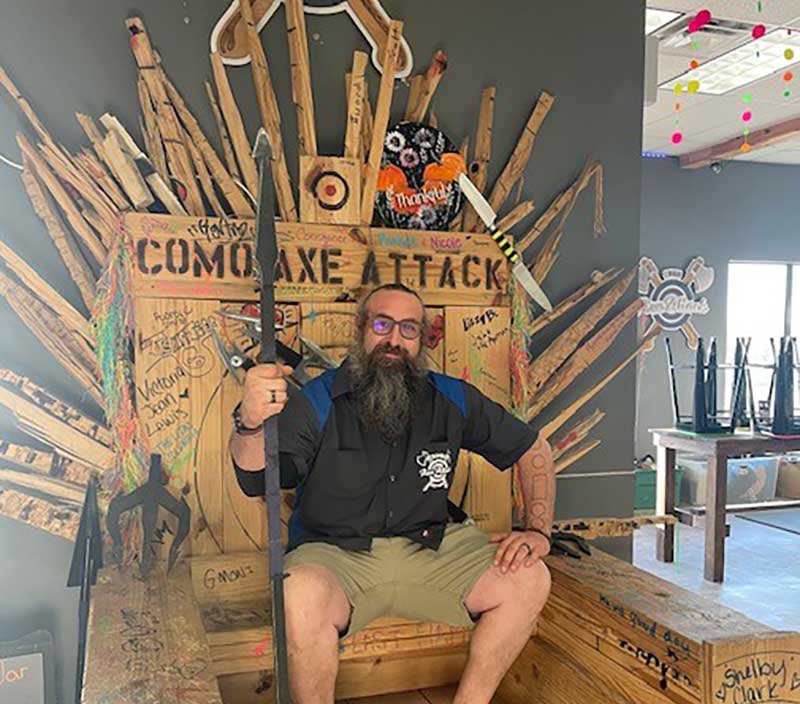 The owner of Witches And Wizards Arcade sits on the venue's throne