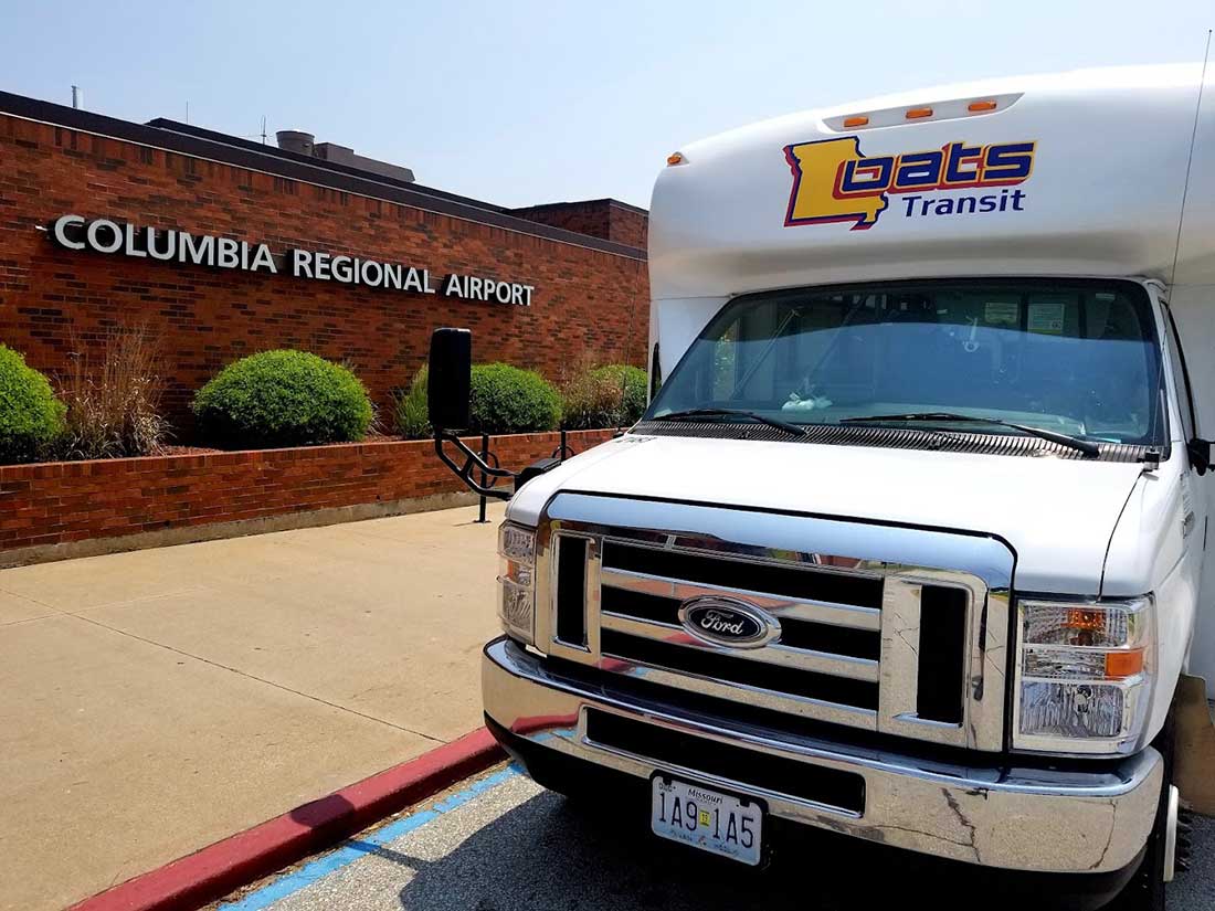 Como Extra Oats transit bus parked outside the Columbia Regional Airport