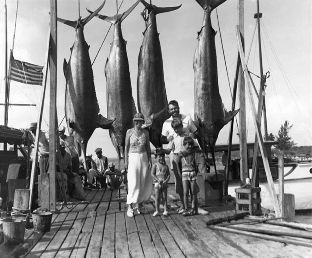 Author Ernest Hemingway poses off Key West, Fla., to show off a nice catch of marlins with his wife, Pauline, and their sons.