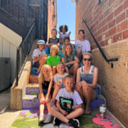 Wendi Jensen Poses In The North Village With A Summer Camp Group Of Kids