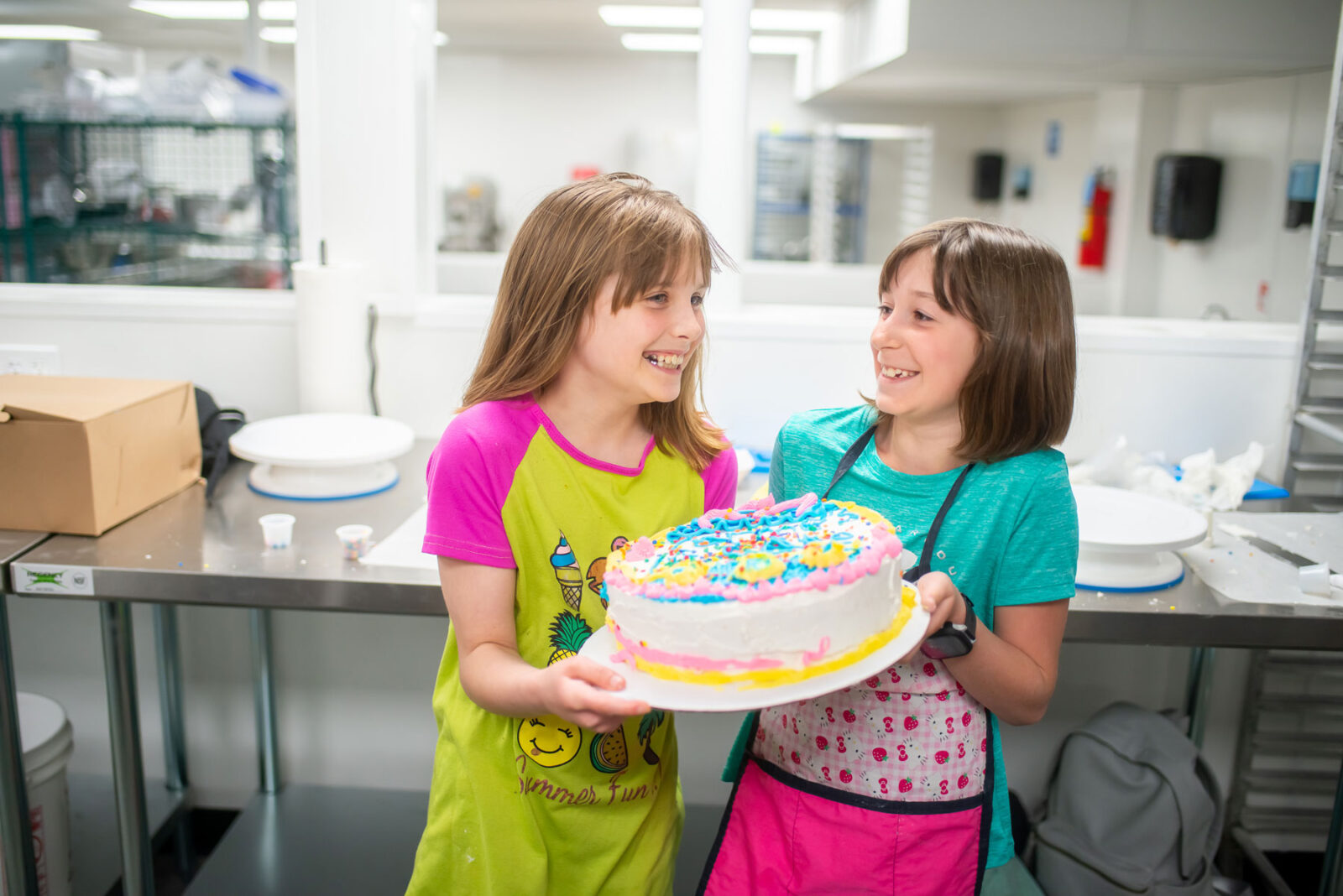 Girls Holding First Cake