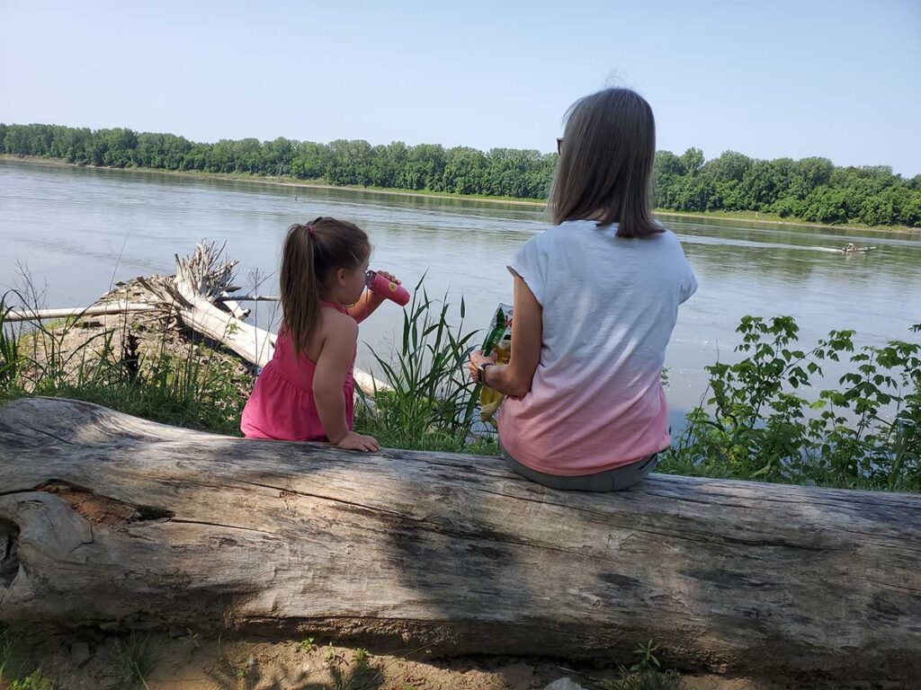 Four-year-old Georgia Zimny and her grandma, Denny Zimny, of Hartsburg, watch the Missouri River roll by Thursday, June 15, during Mornings at the River at Cooper's Landing.