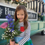 Blooms and Wishes Flowers: a little girl holding a bouquet
