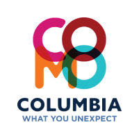 Columbia Visitor's Bureau logo. CO on top of MO, spelling COMO. "What you unexpect"