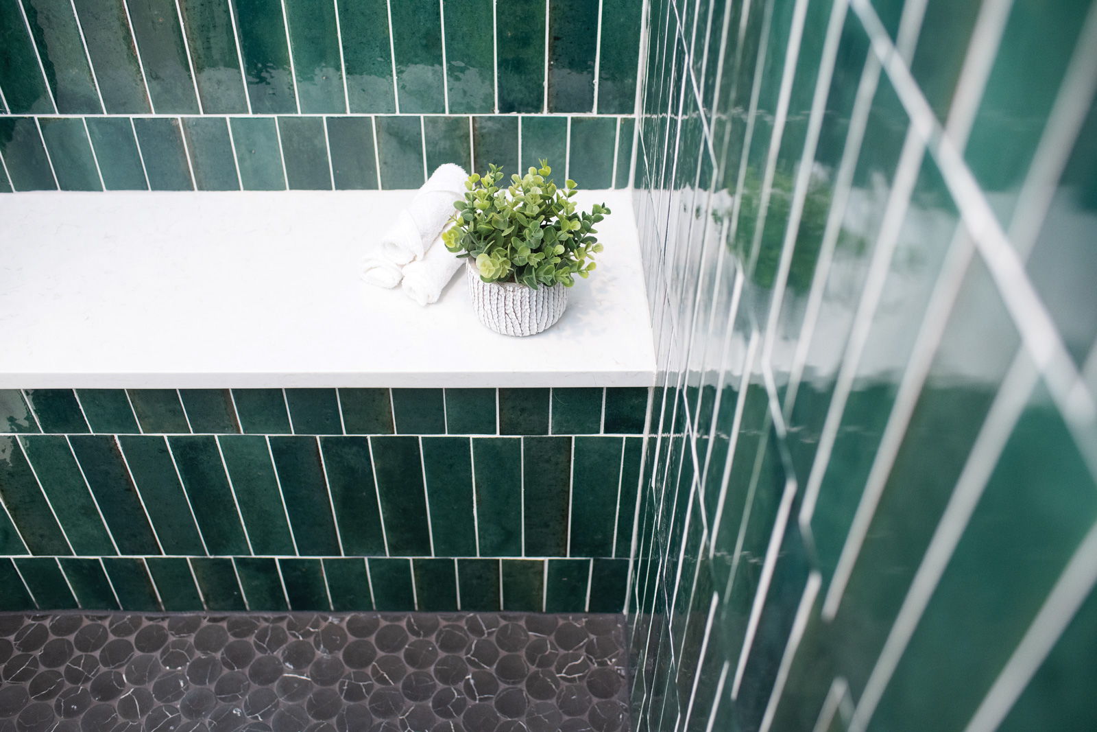 Decor details in green tiled shower