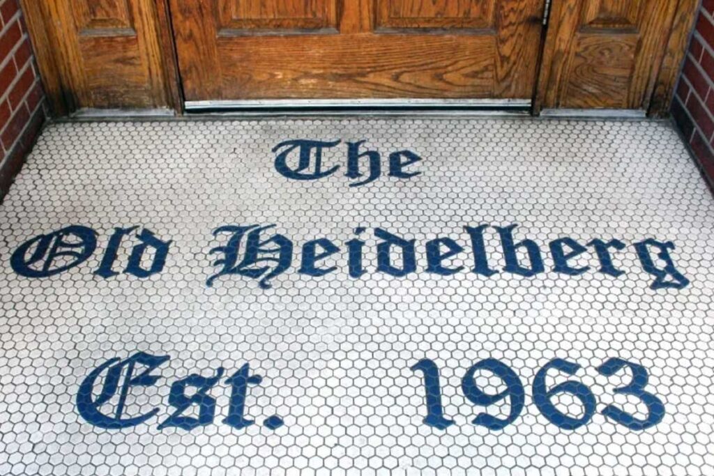 The entrance to The Heidelberg in Columbia, Missouri, has a tile welcome that reads 