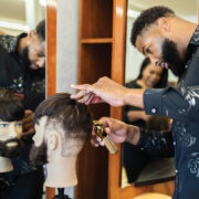 Student works on barber skills by working on mannequin