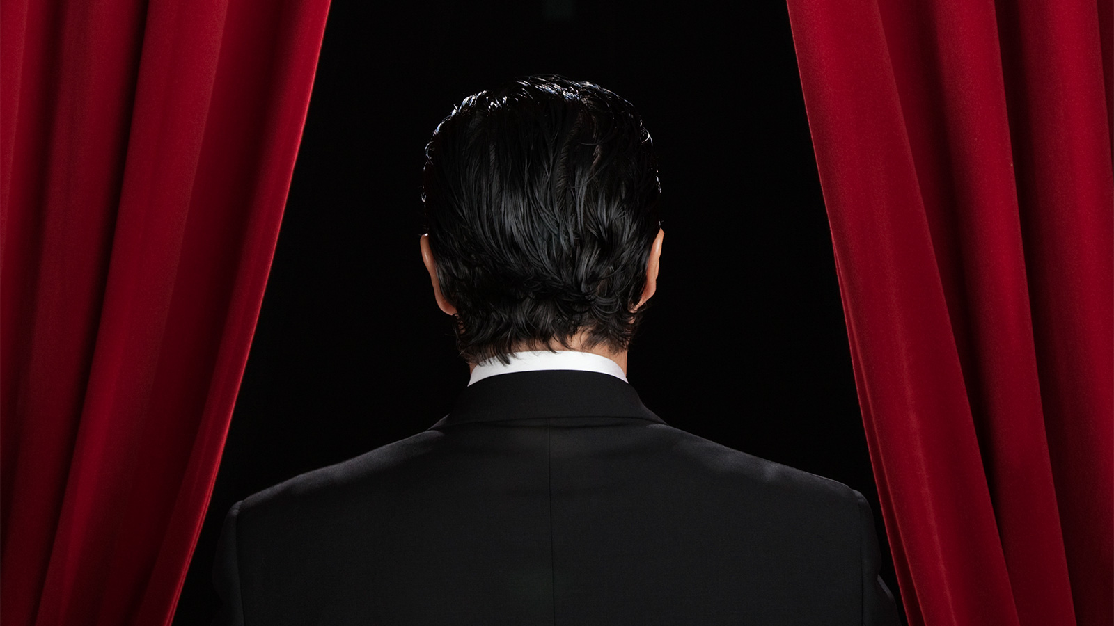 Business Man Standing Behind Curtains On Stage Featured