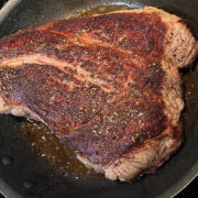 Searing a slab of steak on stovetop