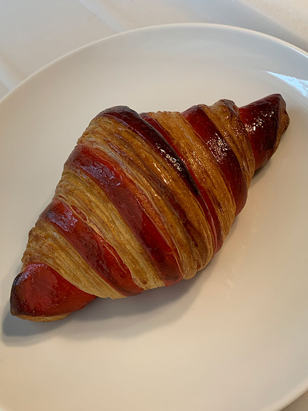 Dual color croissant with red representing the raspberry filling