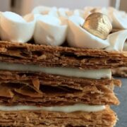 Mille Feuille-"thousand sheets" in French, composed of three layers of puff pastry filled with creamy vanilla pastry cream.