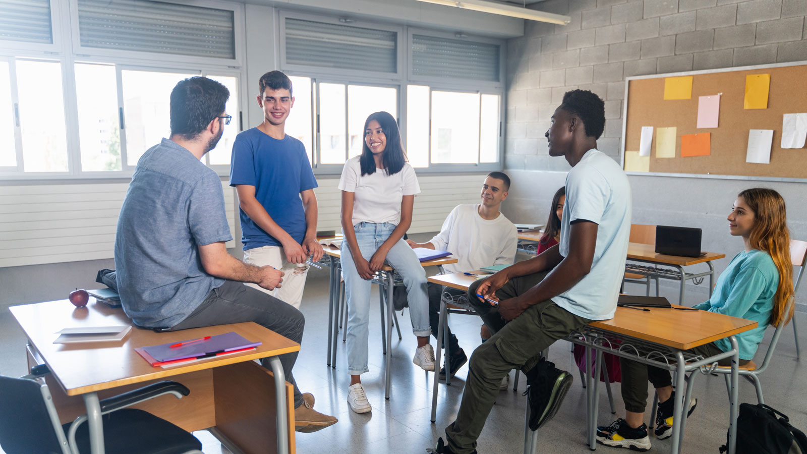 Students and teacher having a conversation at classroom