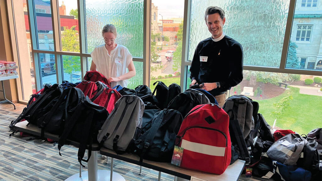 Table full of backpacks to give away at Project Homeless Connect