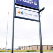 The Food Bank Market and Compass Health exterior signage