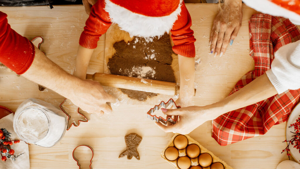 A family prepares to bake Christmas treats together. Getty Images.