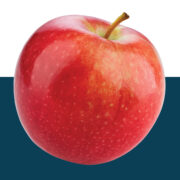 Bright red apple cut out on blue background.
