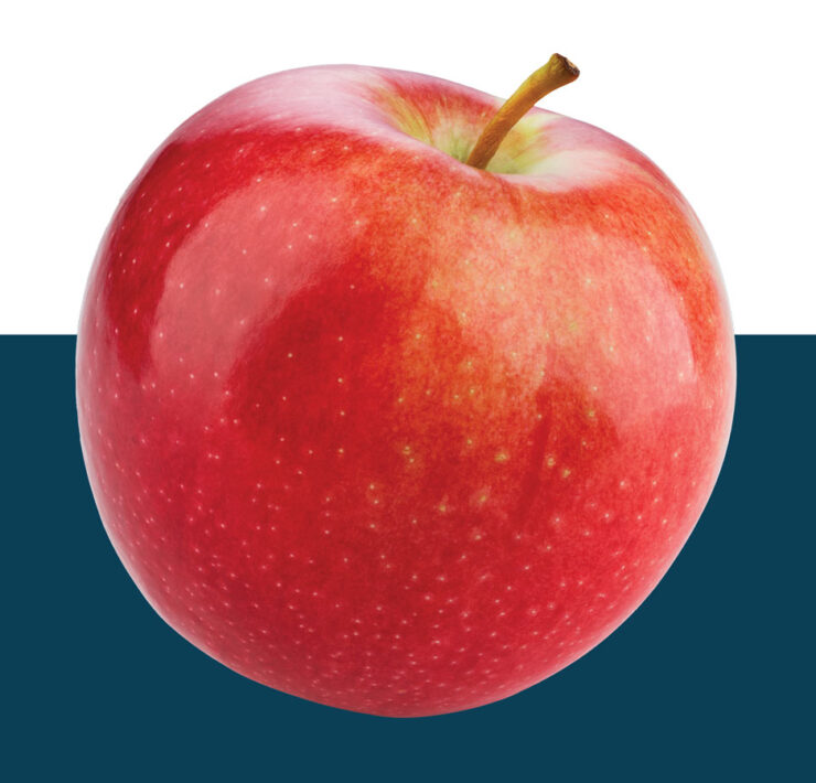 Bright red apple cut out on blue background.