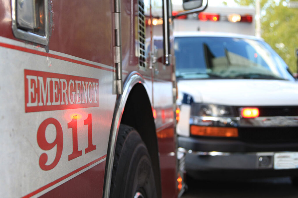 First Responder Gettyimages 147000063 image of the side of a firetruck and ambulance in the distance