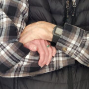 Bob and Priscilla Bartlett's hands and armed joined together