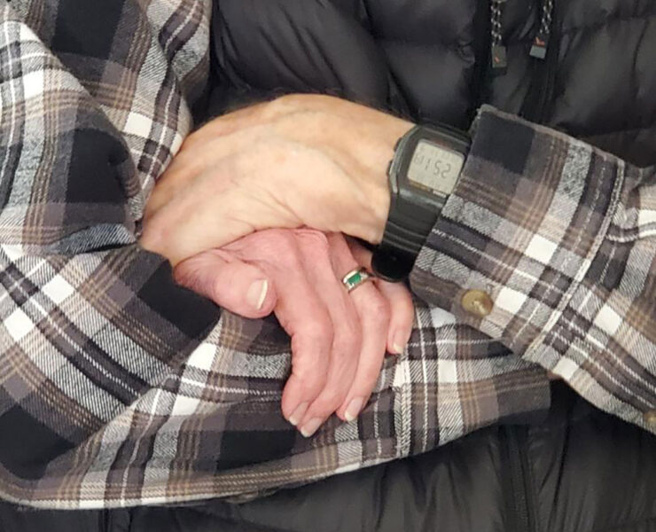 Bob and Priscilla Bartlett's hands and armed joined together