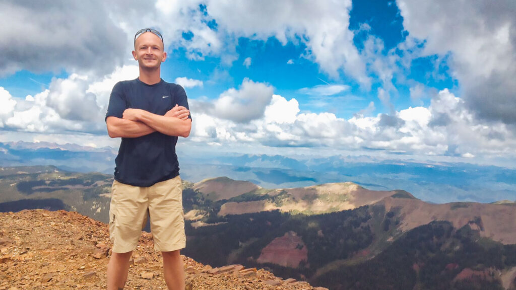 Nathan Todd standing on a mountain