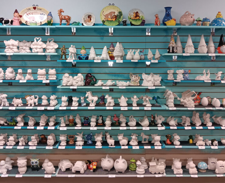 Large Wall of Shelves Filled with Unpainted Pottery Sculptures