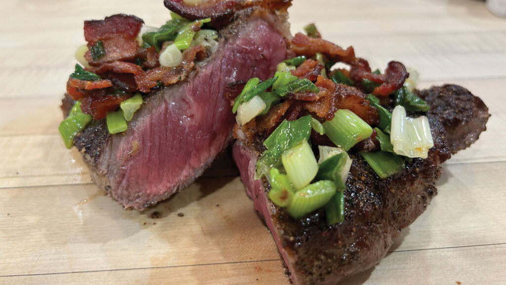 Hoss Koetting's Pepper Steak topped with bacon onion mixture.