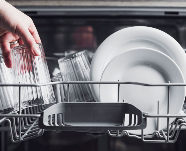 Open Dishwasher With Clean Cutlery Glasses Dishes Inside