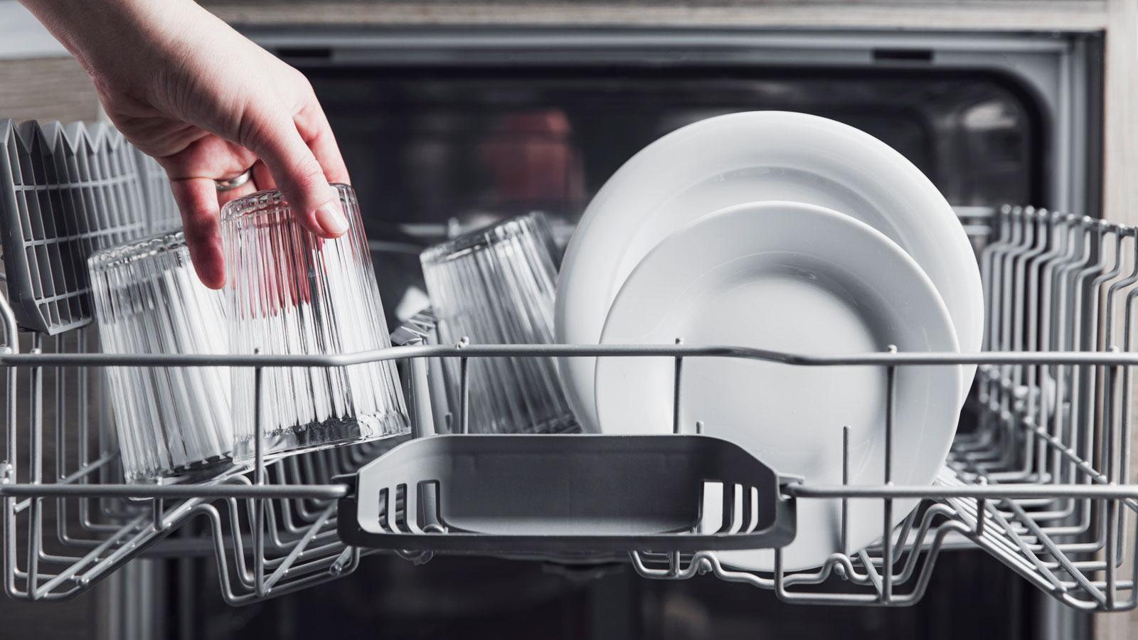 Open Dishwasher With Clean Cutlery Glasses Dishes Inside