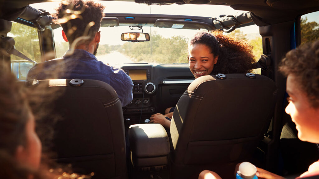 family of four in a car on a Roadtrip