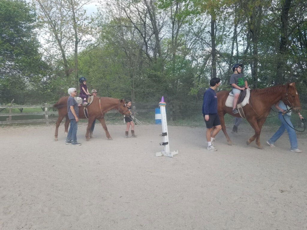 Two riders walking horses at Sunny Oak.