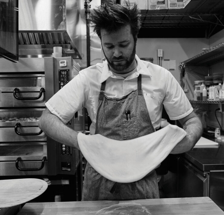 Endwell Taverna Kitchen chef stretching Pizza Dough