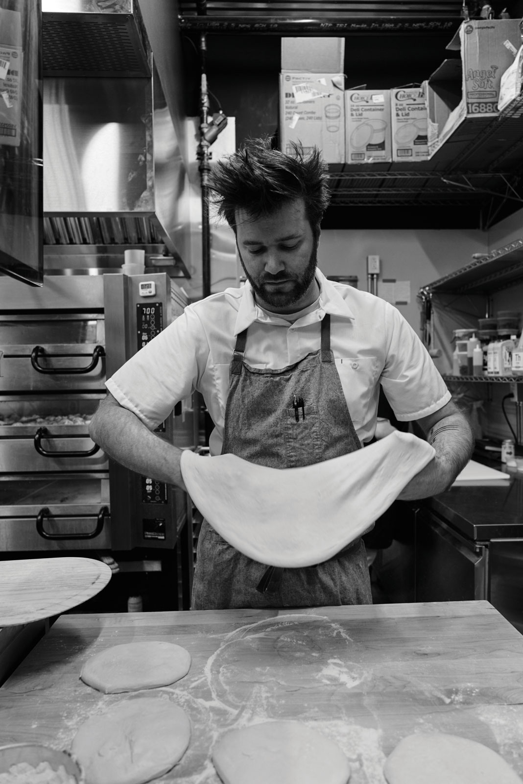 Endwell Taverna Kitchen chef stretching Pizza Dough