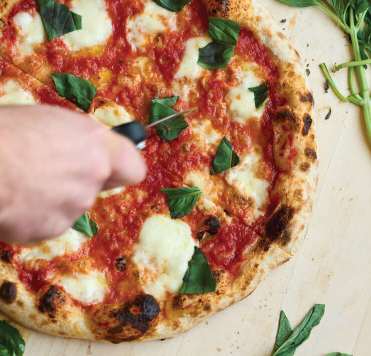 Endwell Taverna slicing the pizza