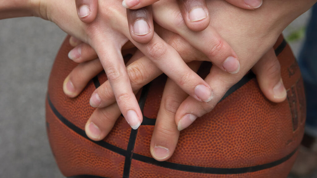 Hands in on a basketball