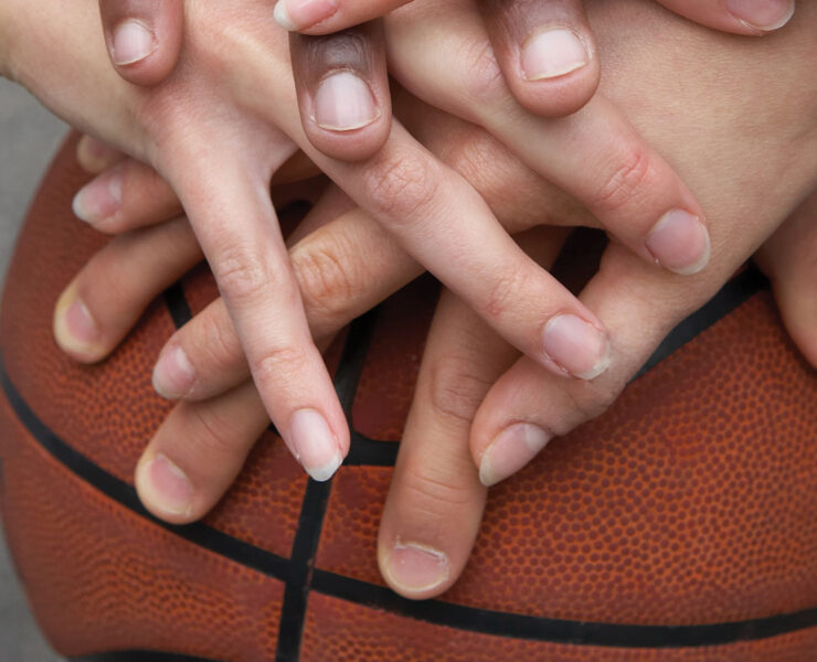 Hands in on a basketball