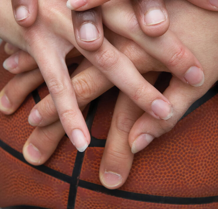 Hands in on a basketball