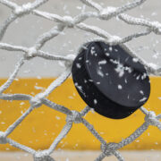 Ice hockey puck hitting the net