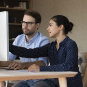 Man and Woman Looking at Computer Screen