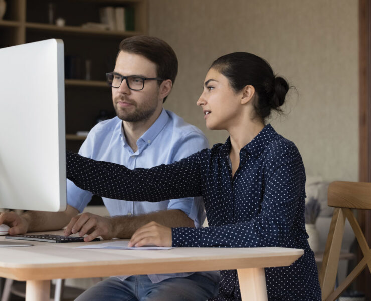 Man and Woman Looking at Computer Screen