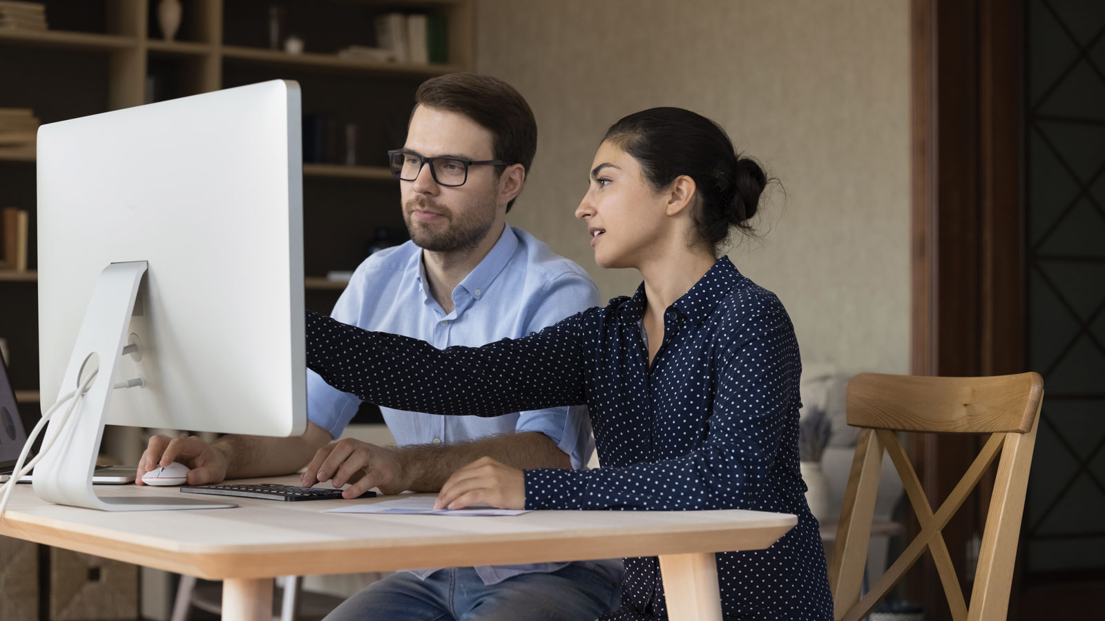 Man and Woman Looking at Computer Screen