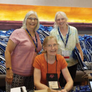 Columbia Spinners Guild: Paula McFarling, Susan Burpo stand while Jean Williams is seated.