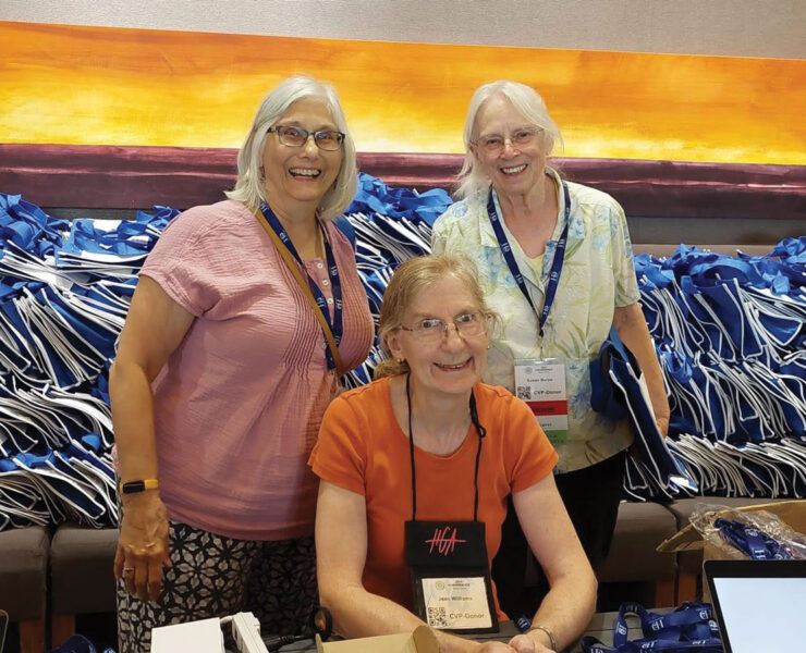 Columbia Spinners Guild: Paula McFarling, Susan Burpo stand while Jean Williams is seated.