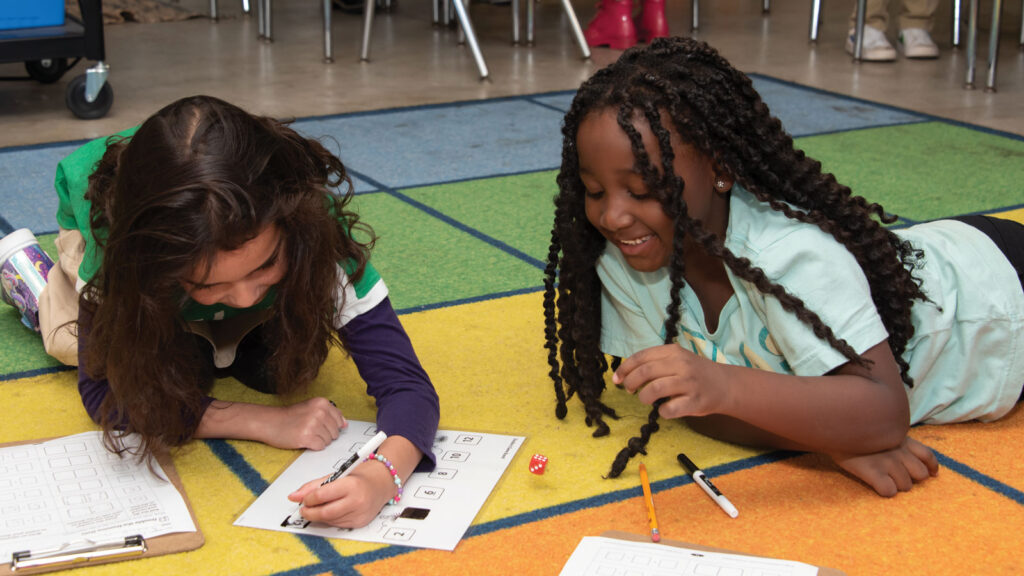 Students working on floor at Atlas Charter School