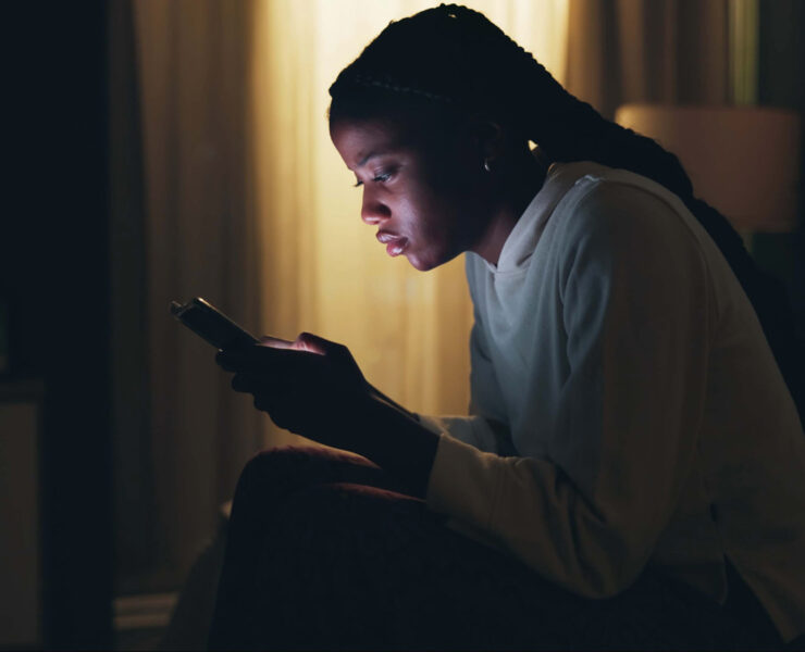 A Stressed Out Teenager Stares At Her Bright Phone Screen