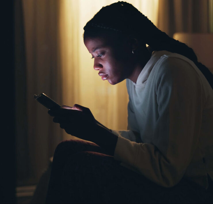 A Stressed Out Teenager Stares At Her Bright Phone Screen