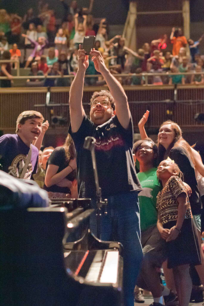 Arturo O'Farrill captures an energetic selfie at one of his annual kid's concerts at the Hickman auditorium.